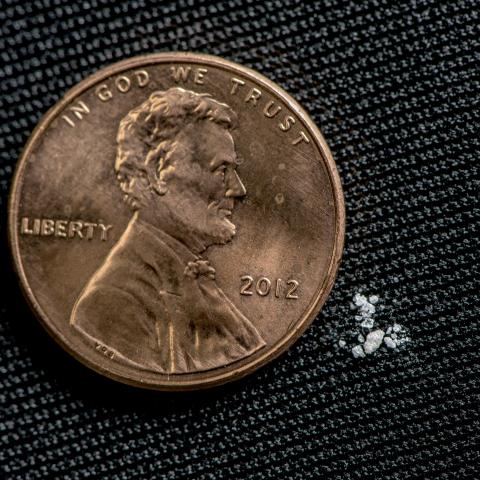 a lethal dose of Fentanyl next to a penny.