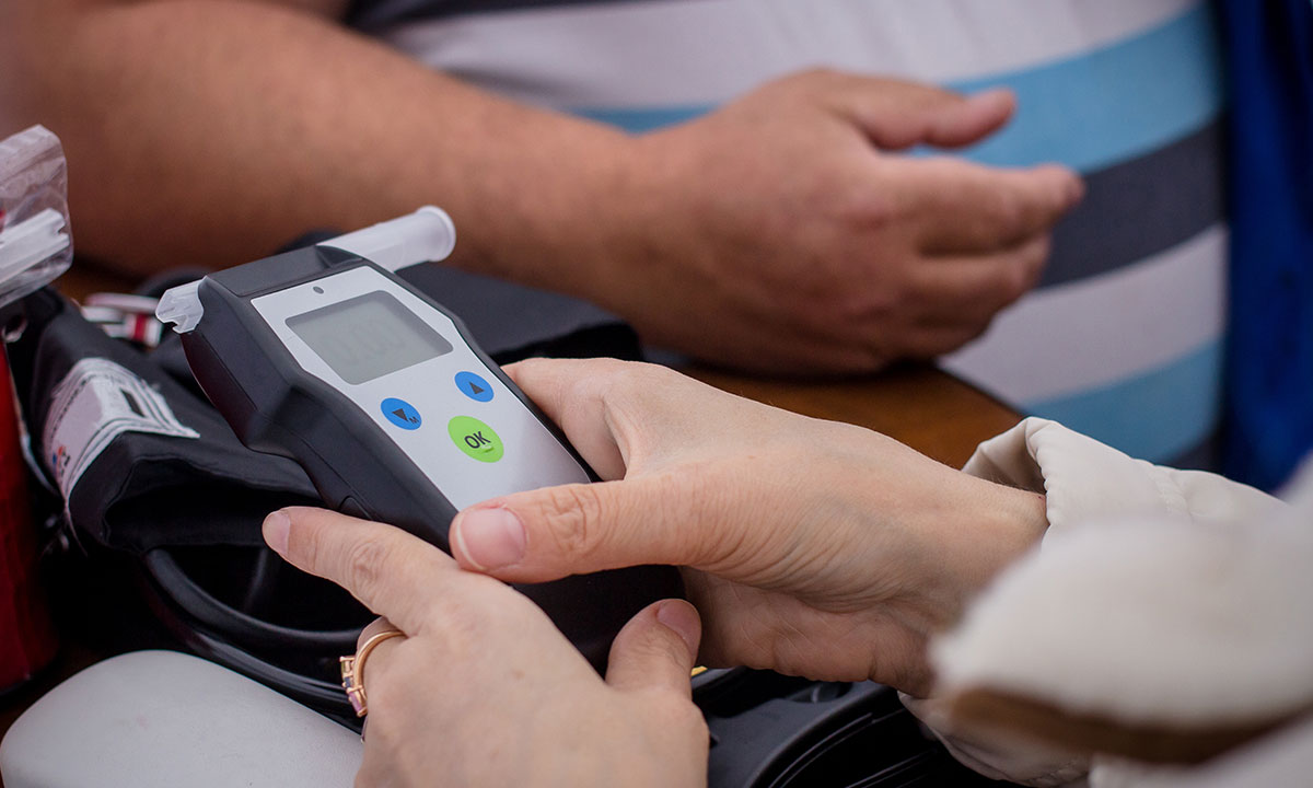 Security professional using a radio for communication while on duty, representing workplace safety and compliance services