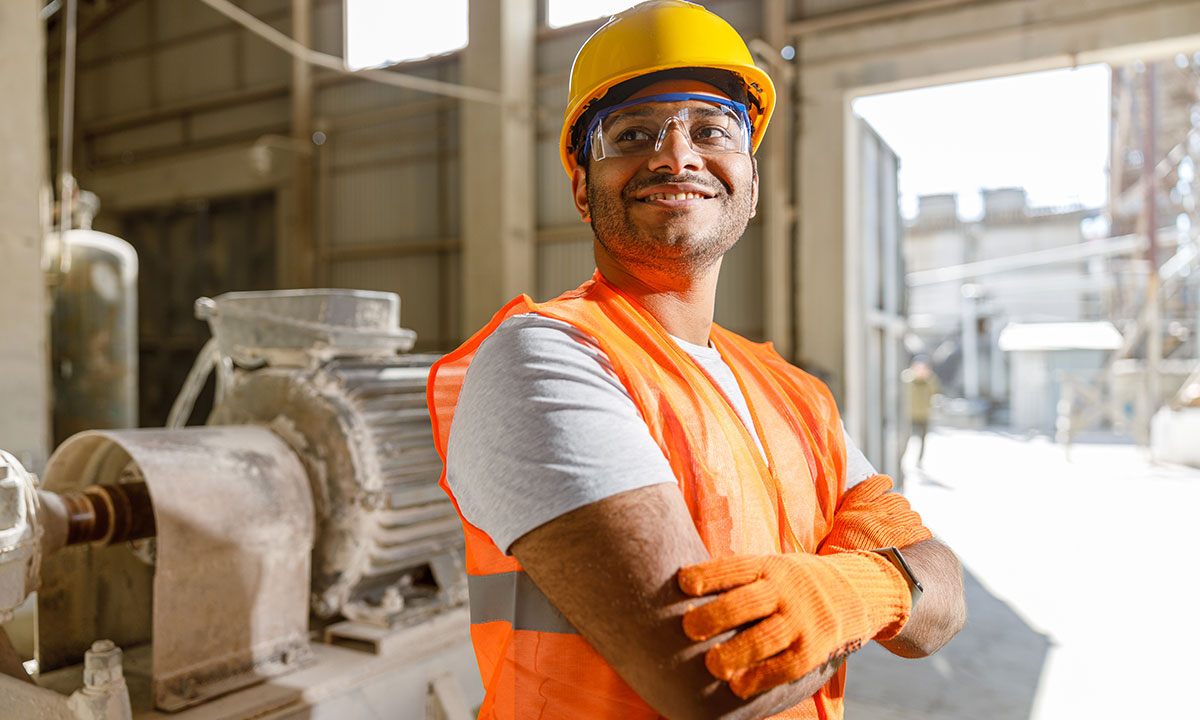 Security professional using a radio for communication while on duty, representing workplace safety and compliance services